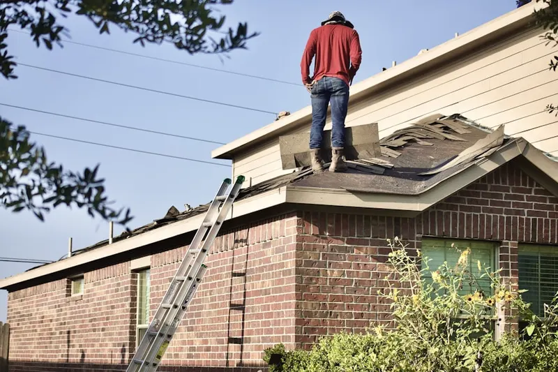 Professional roofer working on a residential roof in Camp Burgess